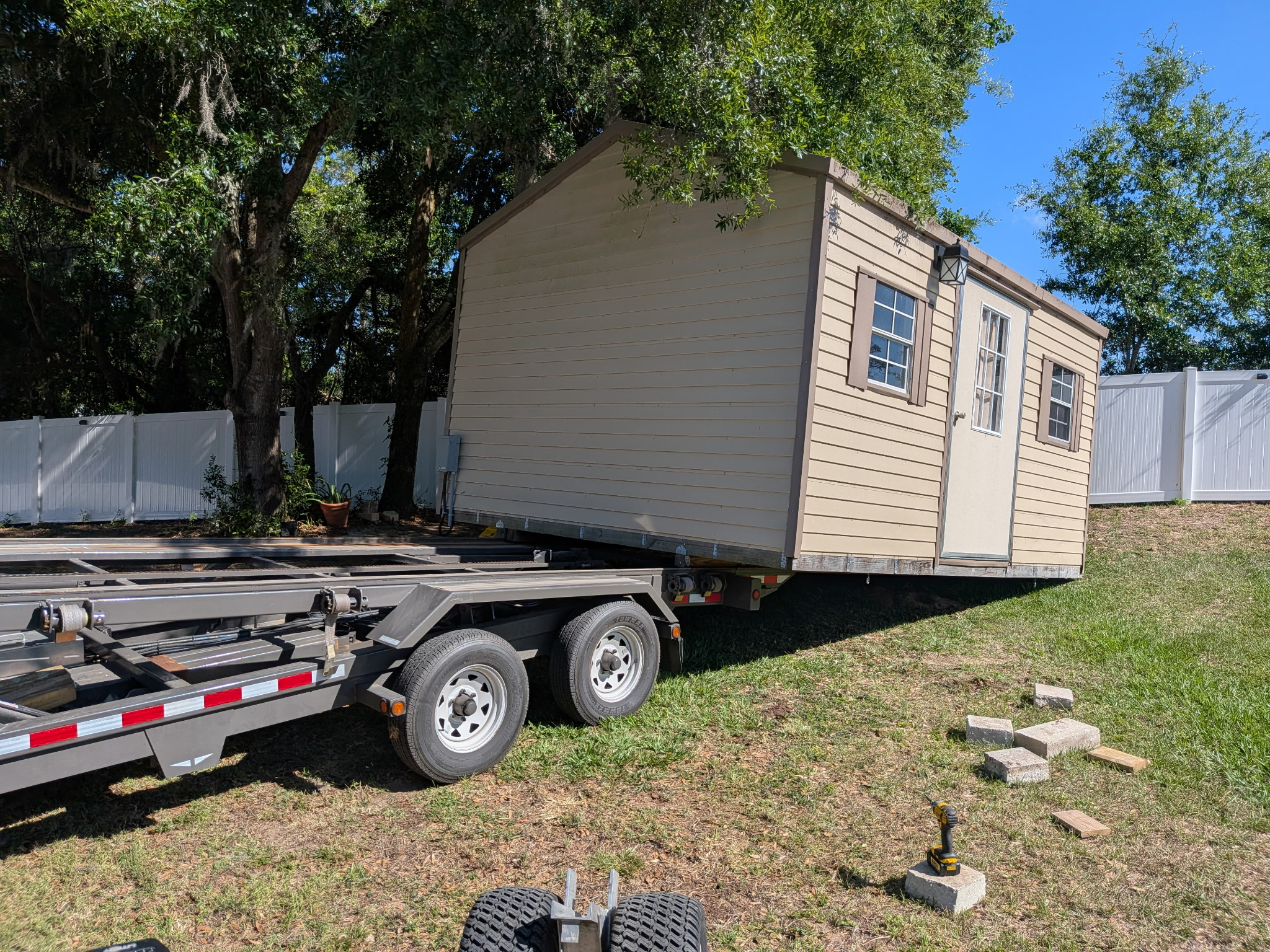 biege shed coming off trailer