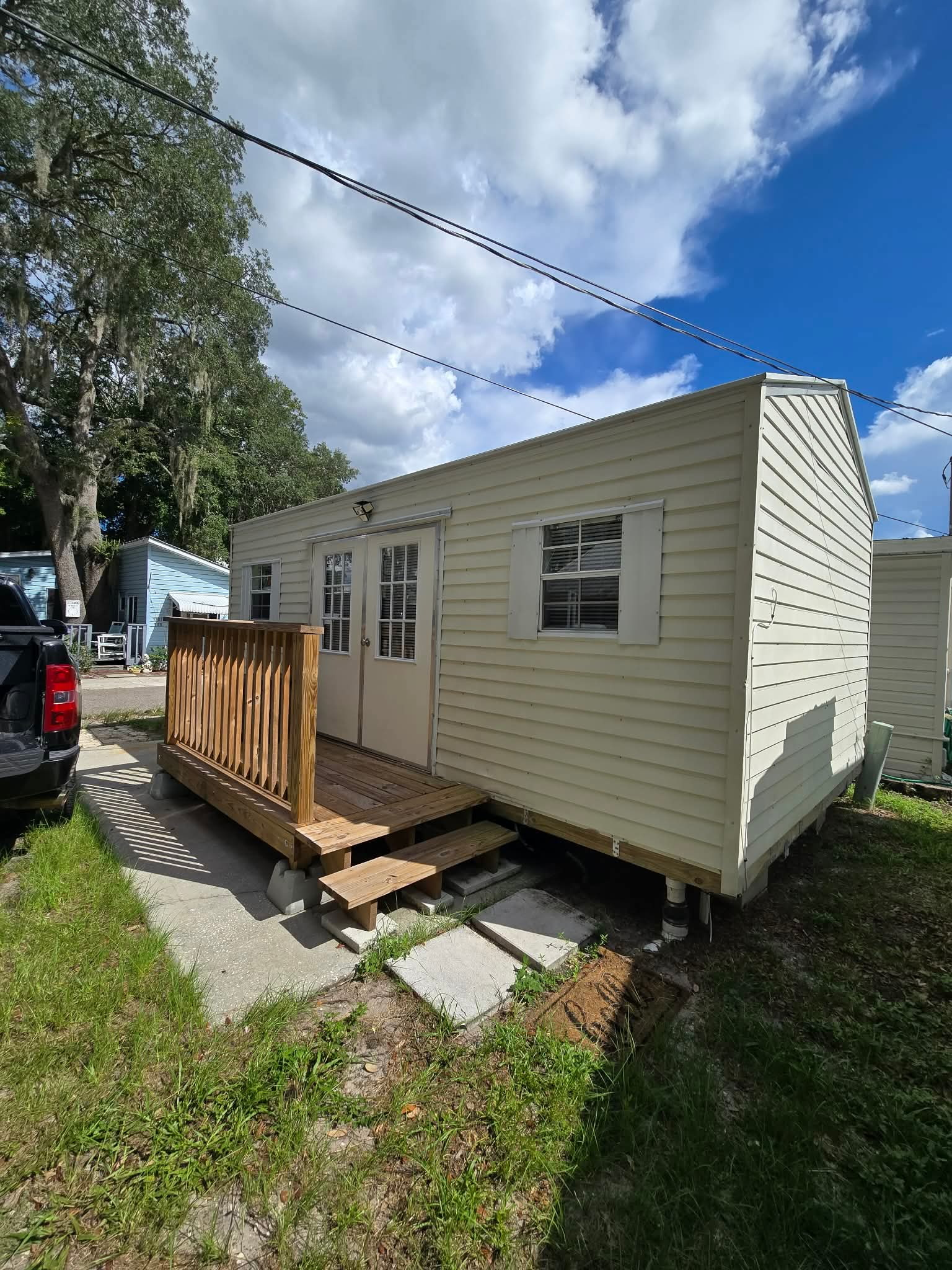 yellow shed with wooden porch